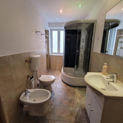 a bathroom with a toilet and a sink and a shower at Central 2 Budget Accomodation in Bucharest