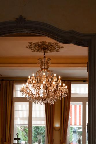 a chandelier hanging from a ceiling in front of a window at Hotel Botticelli in Maastricht