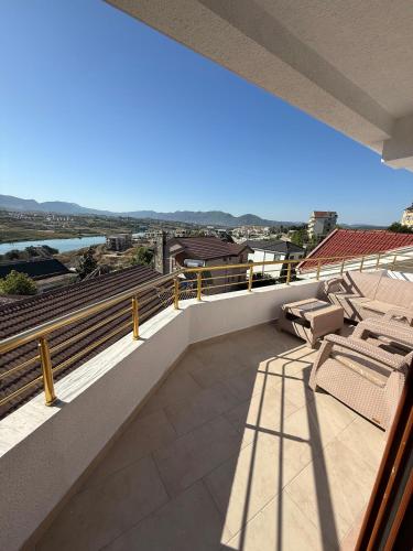 a balcony with chairs and a view of the water at Murati Lake View Hotel in Tirana