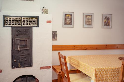 a dining room with a table and a fireplace at Bruderhaus 18 in Vöröstó