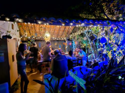 een groep mensen die 's nachts aan een bar zitten bij Pousada JeriMagia in Jericoacoara