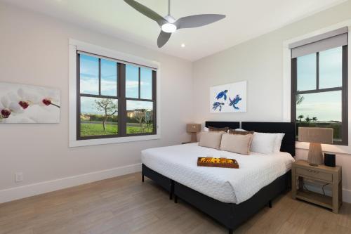 a bedroom with a bed and a ceiling fan at PiH: Hale Kailani Heated Private Pool Spa in Waimea