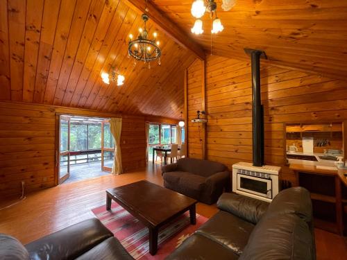 a living room with a couch and a stove at Nakadaki Art Village in Isumi
