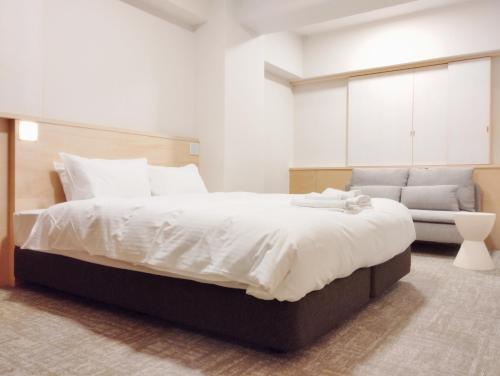 Apartment Hotel DIG the OSAKAにあるベッド