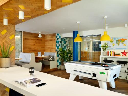 a living room with a ping pong table at For Students Only Studios at SC Edinburgh in Edinburgh