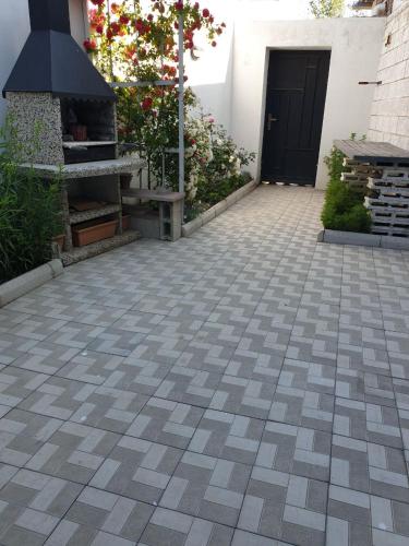 a patio with a fireplace and a black door at VIALPI Guest House in Gyumri