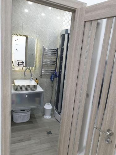 a bathroom with a sink and a mirror at VIALPI Guest House in Gyumri