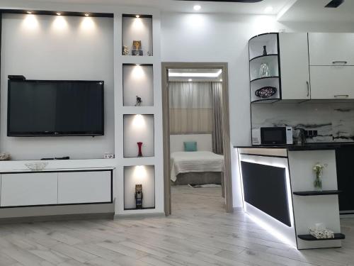 a living room with a flat screen tv on a wall at VIALPI Guest House in Gyumri