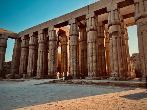 a large building with columns on the side of it at Winter apartment in Luxor