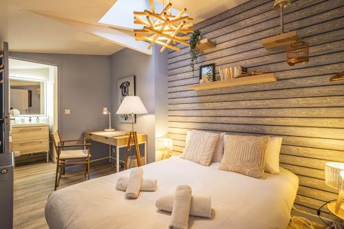 - une chambre dotée d'un grand lit avec un mur en bois dans l'établissement Domremy HypercentredeReims, à Reims