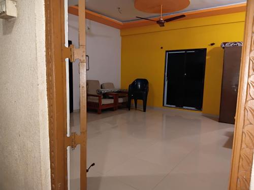 a view of a room with a table and a chair at Heramb homestay in Malvan