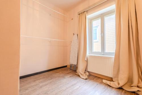 a room with a window and a curtain at Whats-App Self-Check-IN - Bad Aussee City House in Bad Aussee