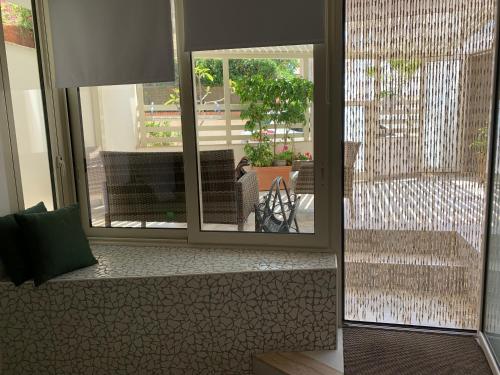 a view of a room with a window and a patio at BALATA home in Marina di Ragusa