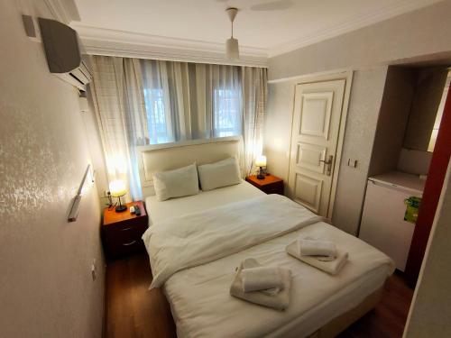 Postel nebo postele na pokoji v ubytování Hotel Antique