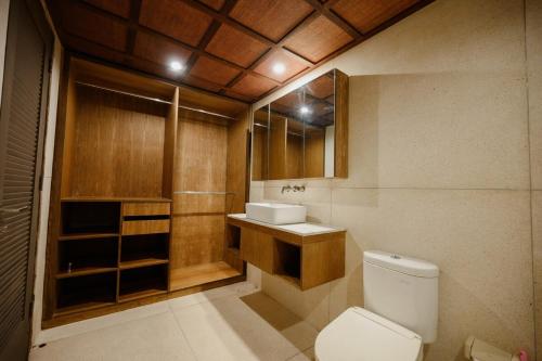 a bathroom with a toilet and a sink at Urban Villas 5BR in Legian