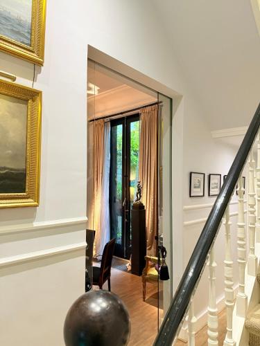 a staircase with a glass door leading into a room at Bourgogne Suite Maastricht in Maastricht