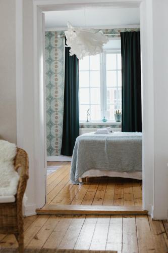 a bedroom with a bed and a large window at STF Gysinge Wärdshus & Hotell in Gysinge