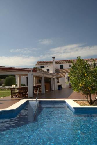 a house with a swimming pool in front of a building at Agroturismo Binissafullet Vell in Sant Lluis
