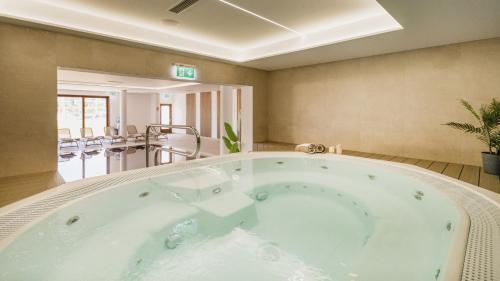 a large hot tub in a room with a balcony at Boutique Hotel Nautica - SPA & wellness, FREE Parking, Pet friendly in Novigrad Istria