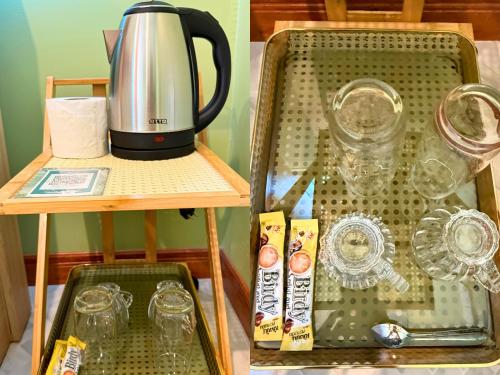 a tray with a tea kettle and glasses on a shelf at สวนไมตรีจิต รีสอร์ท in Ban Khlong Si