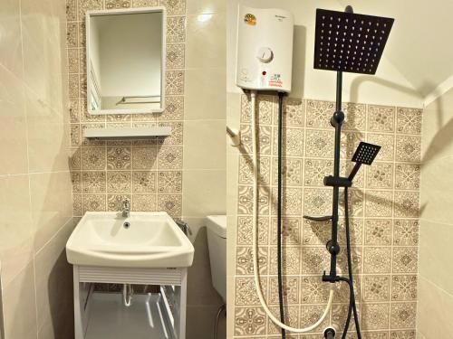 a white bathroom with a sink and a shower at สวนไมตรีจิต รีสอร์ท in Ban Khlong Si