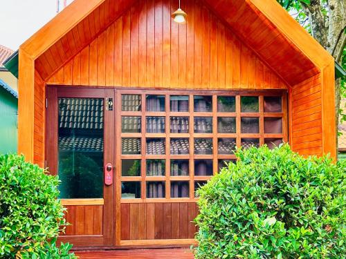 a wooden garage with a glass door at สวนไมตรีจิต รีสอร์ท in Ban Khlong Si