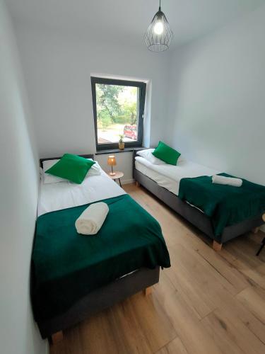 Ένα ή περισσότερα κρεβάτια σε δωμάτιο στο Apartamenty Monte Cassino