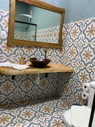 a bathroom with a sink and a mirror at Pousada Rural Vista do Limoeiro in Itabira