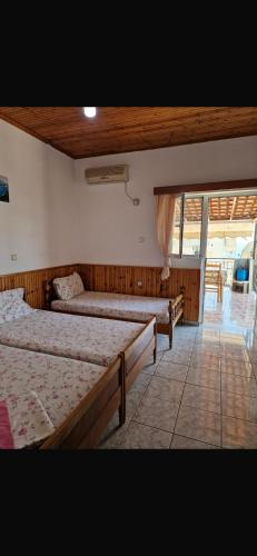a bedroom with two beds and a window at Silvana Room in Himare