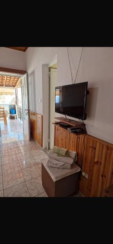 a living room with a flat screen tv on a wall at Silvana Room in Himare
