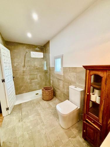 a bathroom with a toilet and a shower at Masia Mimosa in Darnius