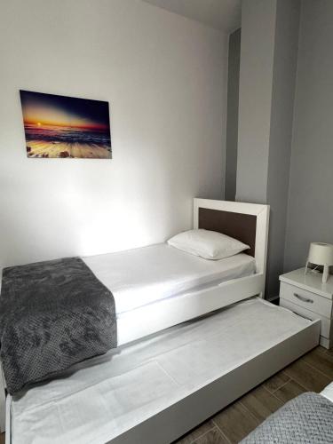 a bedroom with a bed and a painting on the wall at Vila Spiro in Ksamil