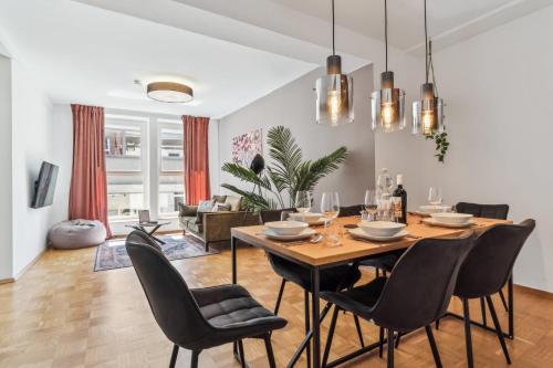 a dining room and living room with a table and chairs at maremar Apartments - Schlafen in der Altstadt - Luxus Boxspring - Küche in Minden