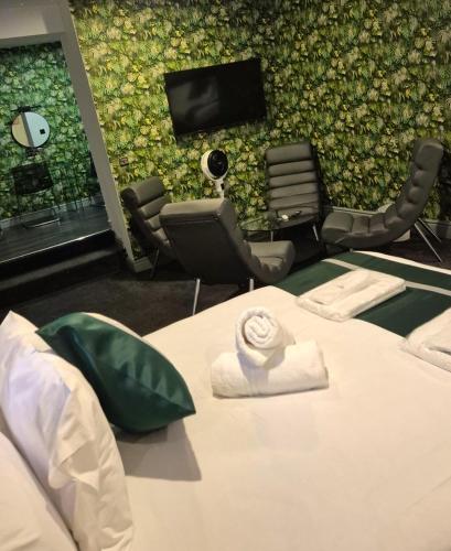 a room with a bed and a wall with a tv at Hotel 105 in Liverpool