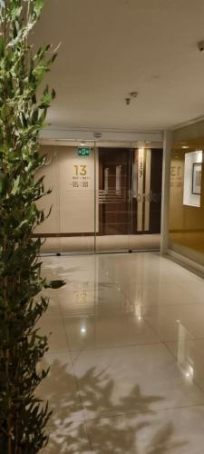a lobby with a plant in the middle of a building at KUBITSCHEK - JK APART Hotel in Brasília