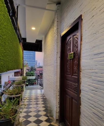 a door on a building with a checkered floor at Sun Chakra Boutique Hotel - 50m to Museum & Royal Palace & Walking street in Phnom Penh