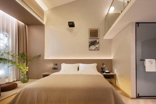a bedroom with a large bed and a window at YujianHotel in Jingdezhen