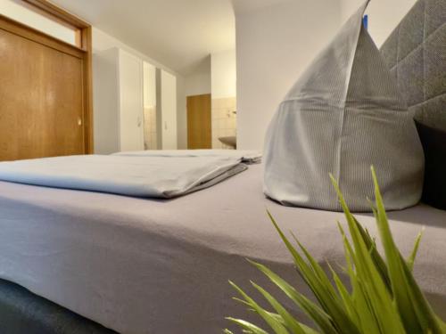 a bedroom with a bed with a pillow on it at Gästehaus Vogel - Silbermöwe in Horumersiel