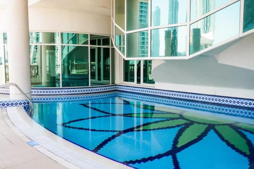 a swimming pool in the middle of a building at Roda Al Murooj Residences in Dubai
