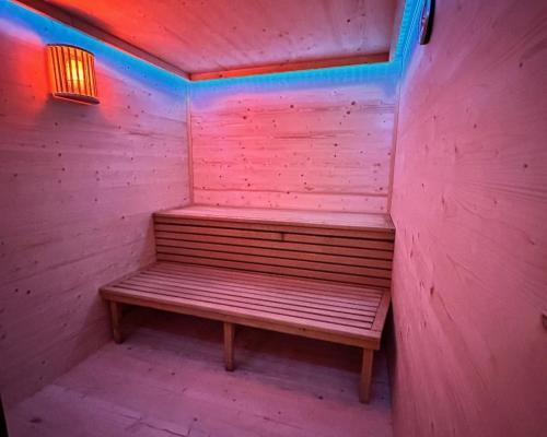 a wooden bench in a pink room with a light at Smart Resorts B&B 2 BB2 320 in Winterberg