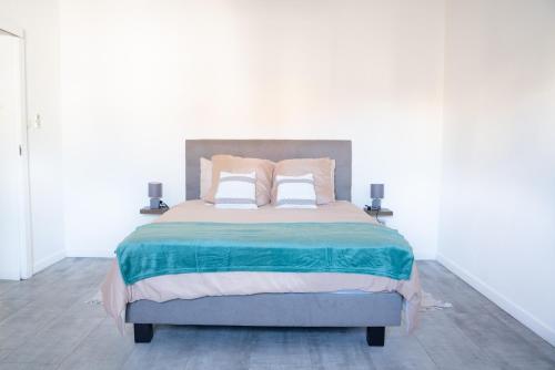 a bedroom with a large bed with two pillows at Ti Caze Boyer - 6 voyageurs in Saint-André