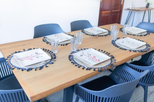 a wooden table with plates and napkins on it at Ti Caze Boyer - 6 voyageurs in Saint-André