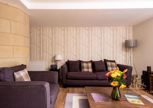 a living room with a couch and a table at The Highland Club in Fort Augustus