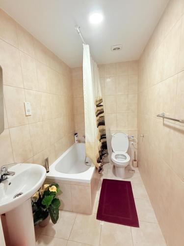 a bathroom with a sink and a toilet and a bath tub at Deluxe Studio in Heart of town in Gibraltar