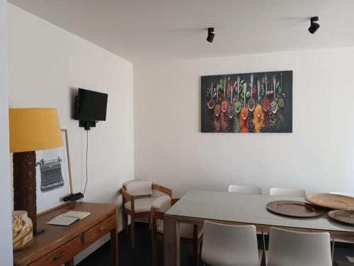 a dining room with a table and a painting on the wall at The Jacob House in Maldegem