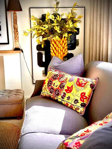 a living room with a couch with a pillow on it at The Jacob House in Maldegem