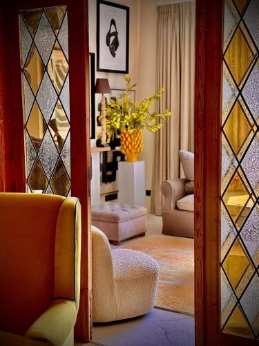 a living room with chairs and a vase of flowers at The Jacob House in Maldegem