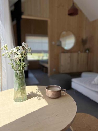 a vase of flowers on a table in a living room at MiłoTu in Równia