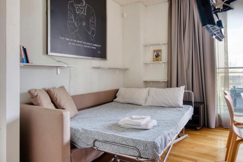 a living room with a couch and a table at GiaxTower Gym Spa & Pool Bright Space in Milan