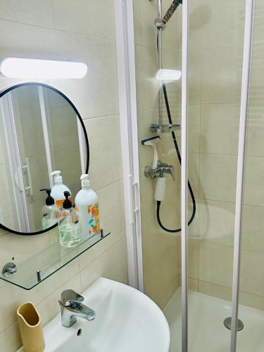 a bathroom with a shower and a sink and a mirror at Studio Malheux centre ville avec terrasse in Trouville-sur-Mer
